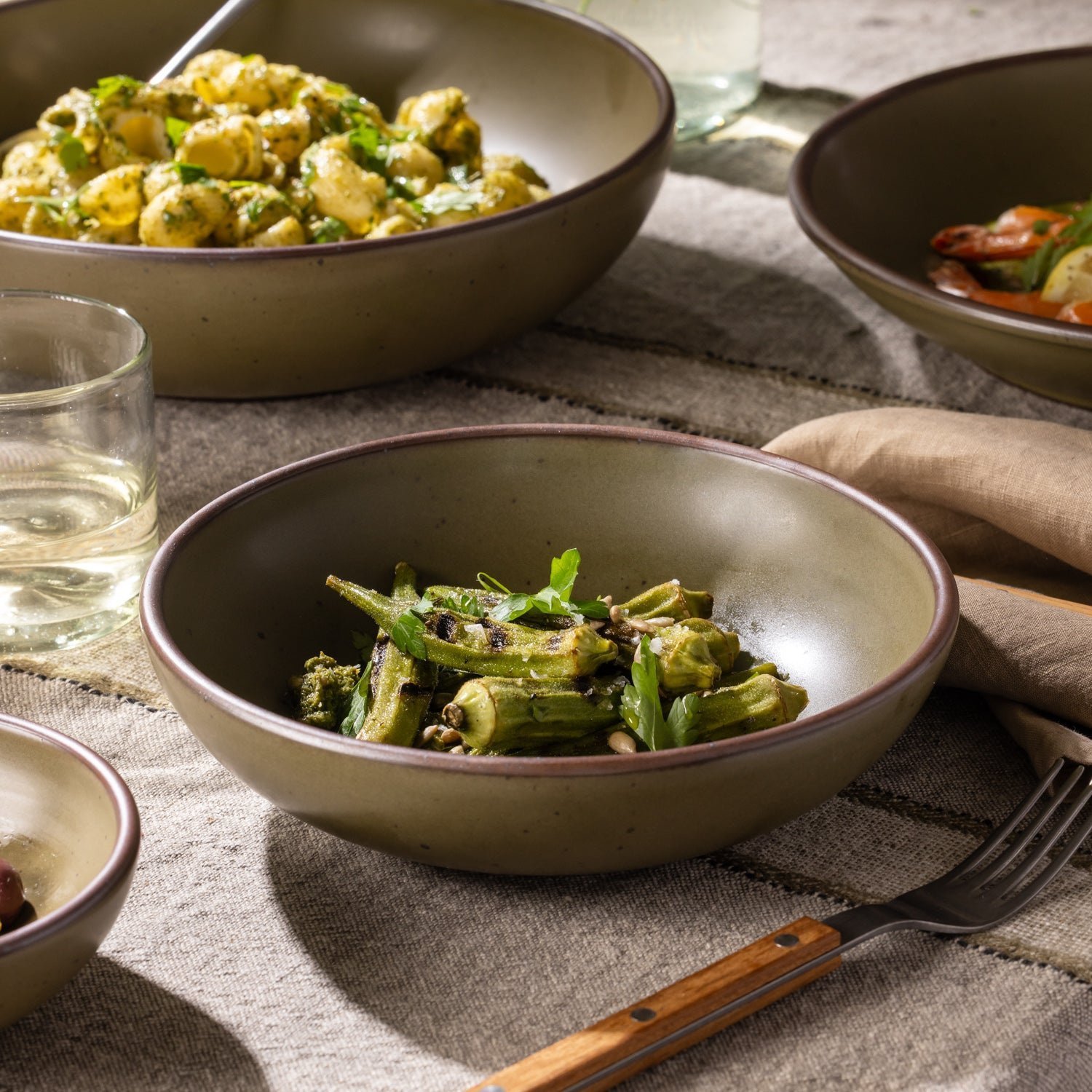 Goallo daily bowl in Pine Green, shown with vegetables in a table setting