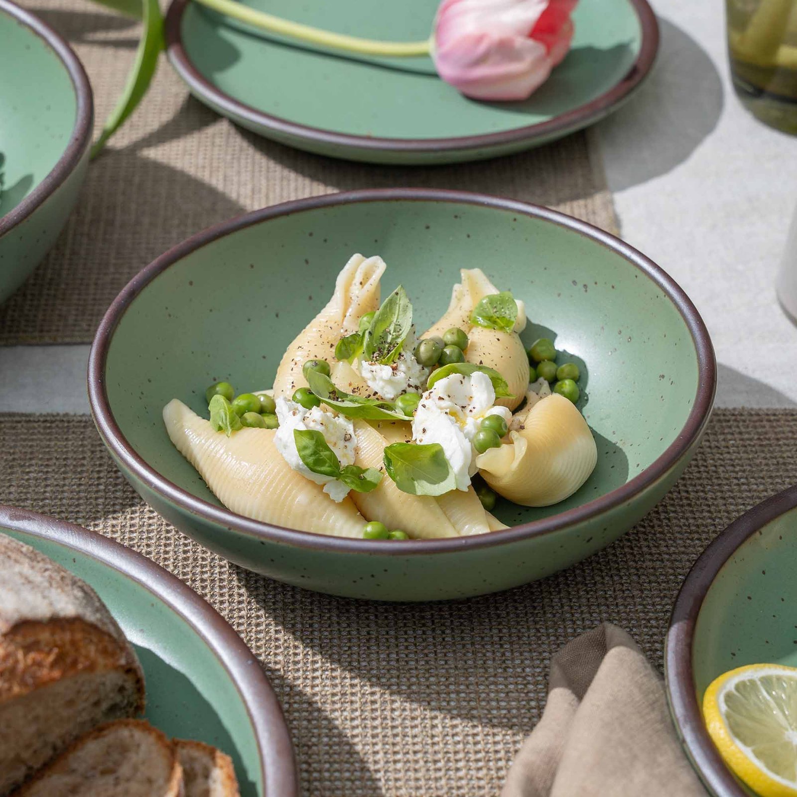 Goallo daily bowl in Viridian, shown with pasta in a table setting
