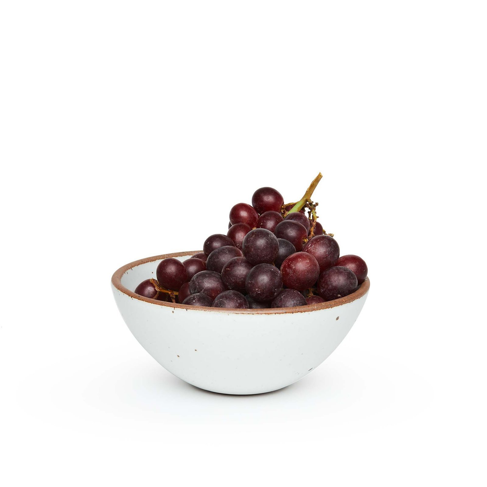 Goallo soup bowl in Cloud White, shown with grapes