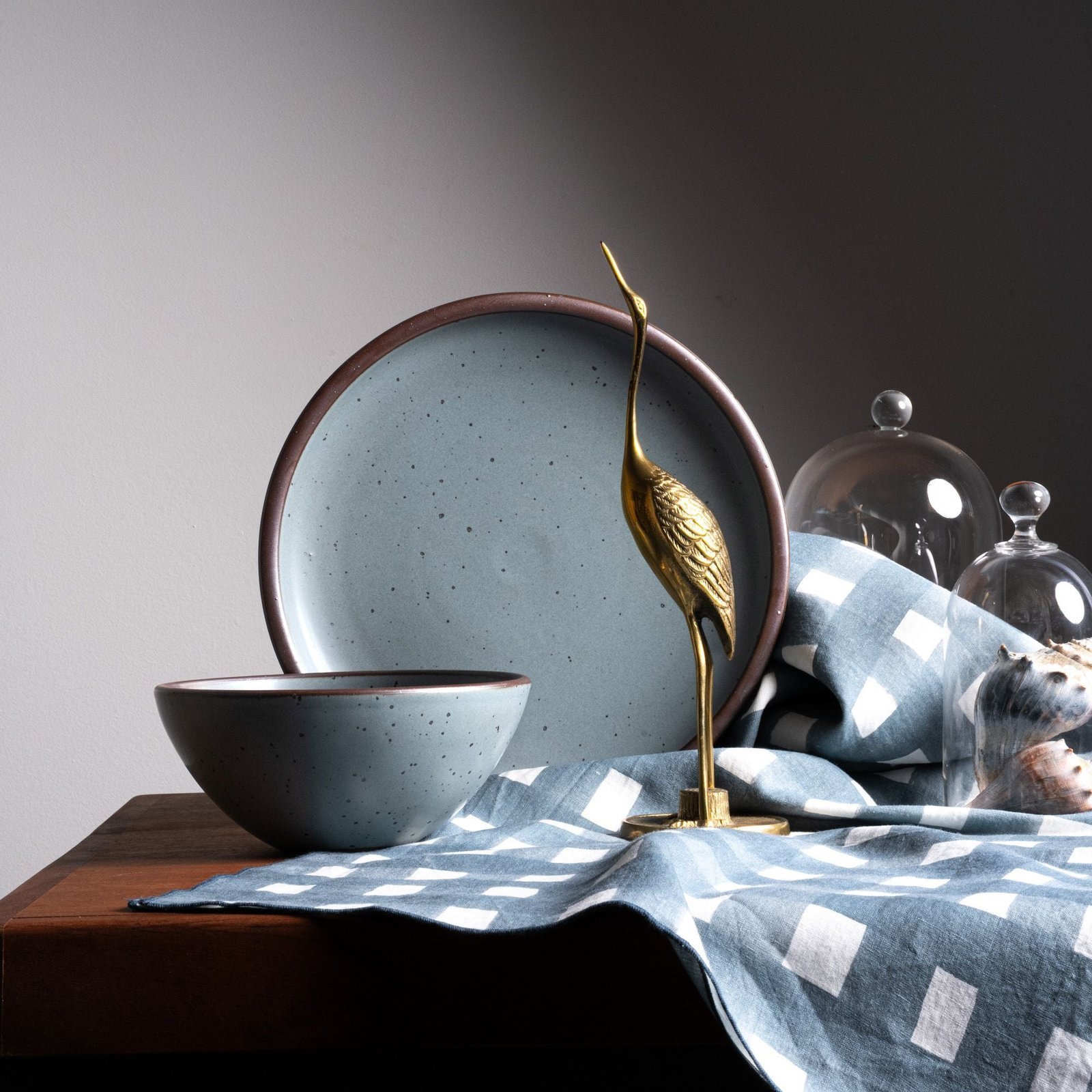 Goallo soup bowl in Mist Blue, in a display with other tableware