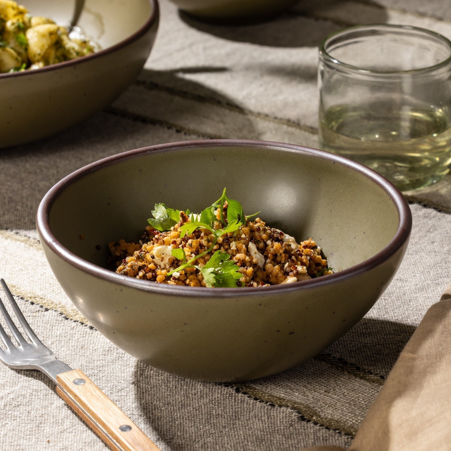 Goallo soup bowl in Pine Green, shown with a grain dish
